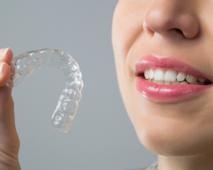 'woman holding invisalign'