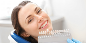 woman smiling sitting in dental chair getting fitted for dental implants